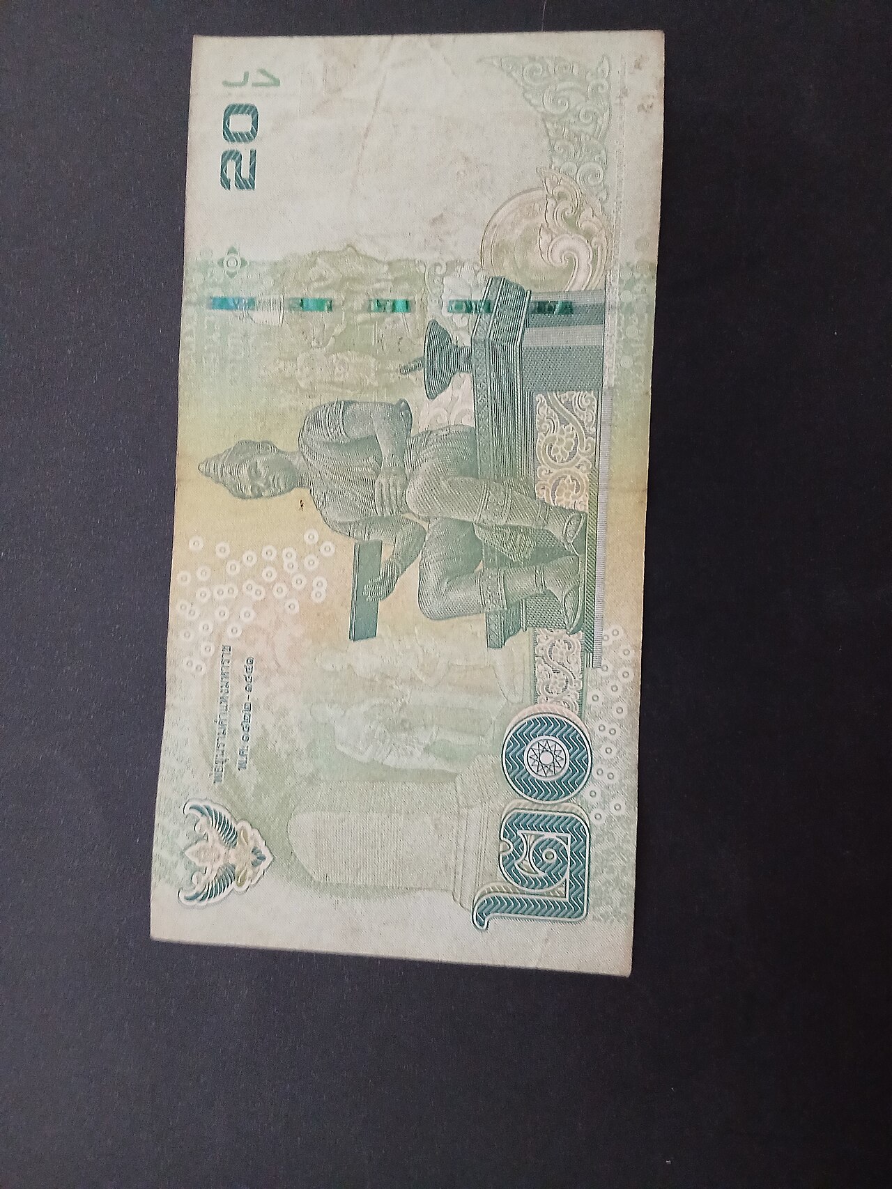 Close-up photograph of a Thai 20 baht banknote, the everyday cash used when living in Thailand as the baht exchange rate moves against the dollar.